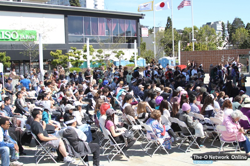 Audience in the Peace Plaza watching a performance.